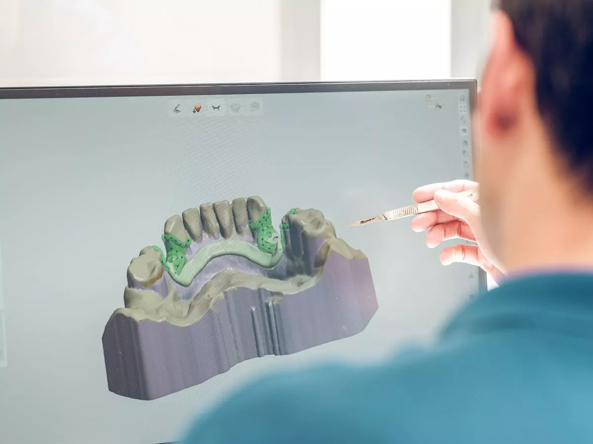 back-view-busy-unrecognizable-blurred-stomatologist-modeling-jaw-computer-while-working-contemporary-clinic