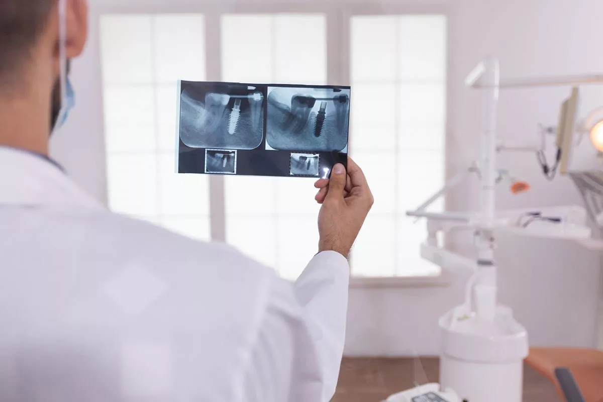 dentist-man-doctor-analyzing-orthodontic-teeth-medical-radiography-working-stomatology-hospital-office-room-background-empty-orthodontist-cabient-preparing-teeth-healthcare-surgery