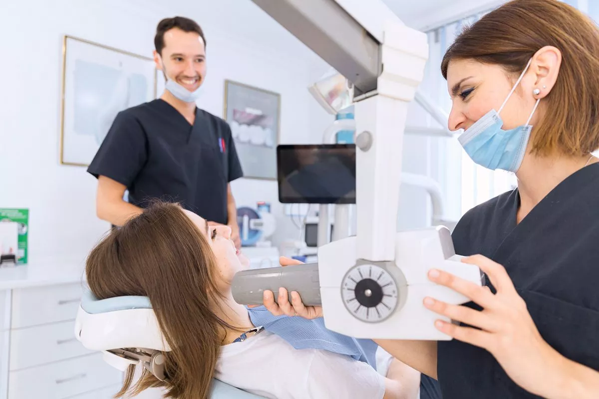 female-dentist-with-x-ray-machine-scanning-patient-s-teeth-dental-clinic-1