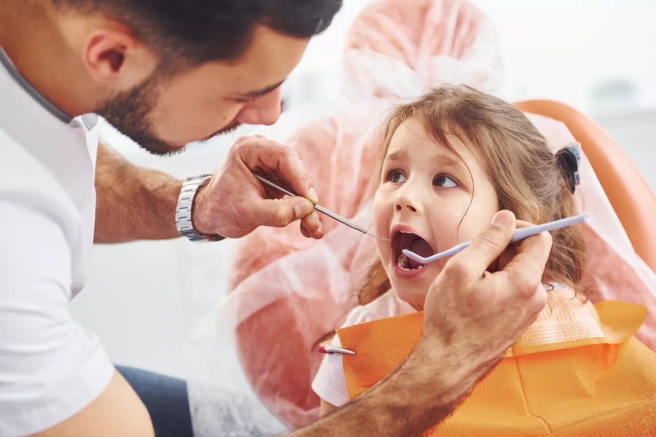 little-girl-visiting-male-dentist-clinic-conception-stomatology